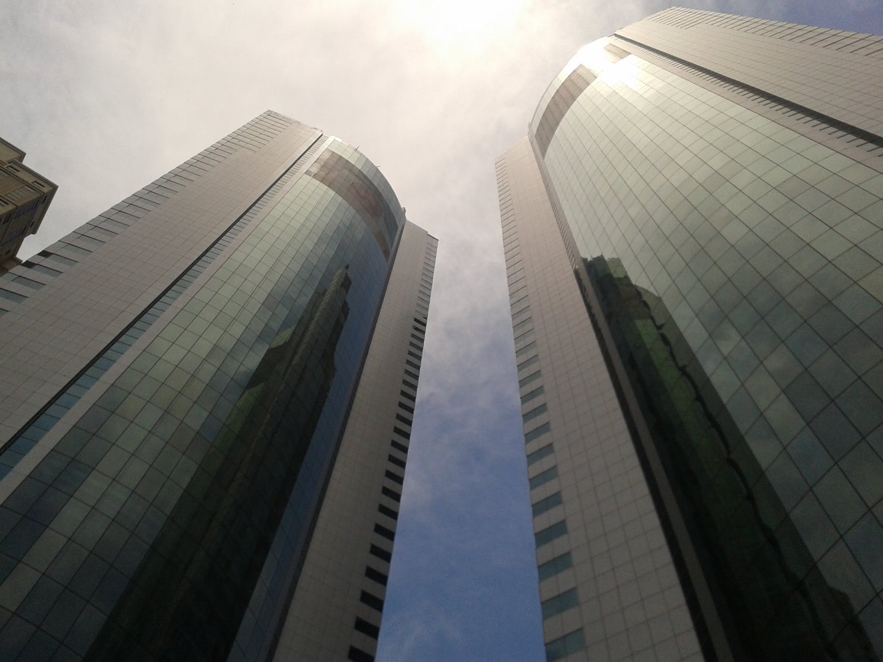 low angle photo of curtain window buildings